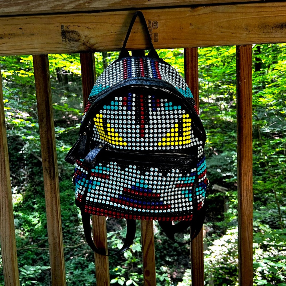 monster face studded backpack